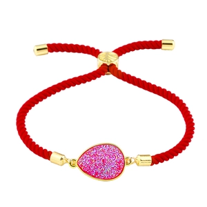 Makroaufnahme des roten Kordelarmbands mit funkelndem rosa Druzy-Tropfenanhänger