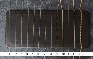 Selection of 13 gold and silver titanium steel necklaces with various chain patterns