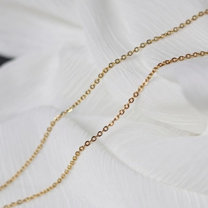 Macro shot of gold-plated thick O-link chain necklace showing intricate metal craftsmanship