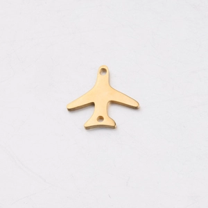Close-up of golden mirror polished stainless steel airplane pendant with double holes