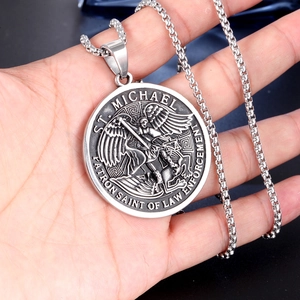 Close-up of Saint Michael medal pendant in silver steel featuring relief details