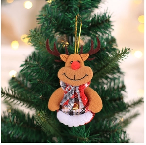Close-up of plush reindeer ornament with plaid scarf hanging on a festive Christmas tree