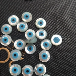 Macro view of loose natural mother of pearl evil eye beads for DIY jewelry making