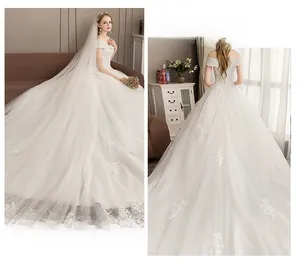 Detail of elegant off-shoulder lace wedding dress with delicate embroidery and corset back