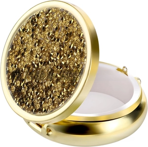 Close-up of golden pill box with sparkling rhinestone lid and three internal compartments