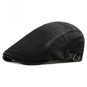 Detail of black mesh newsboy cap showing breathable fabric and metal side buckle