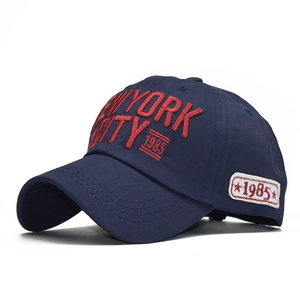 Detail of red 3D embroidery showing NEW YORK CITY text on navy blue cotton baseball cap