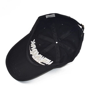 Detail of black cotton baseball cap interior showing adjustable strap and sweatband