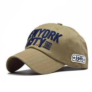Detailed view of 3D embroidery on khaki cotton baseball cap with New York City text