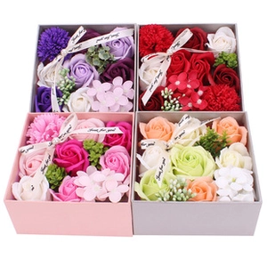 Macro shot of four square soap flower gift boxes in assorted colors with Just for you ribbons
