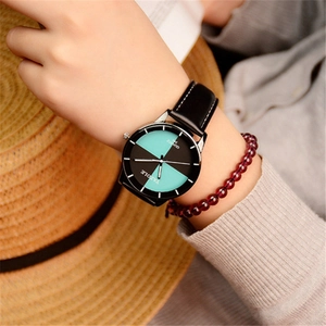 Elegant women's quartz watch with dark green dial and black leather strap worn by a model