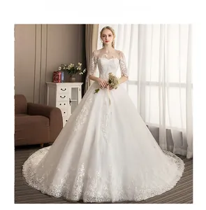 Detailed embroidery on white bridal gown with intricate floral lace and sheer tulle fabric