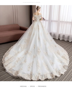 Detailed back view of off-shoulder wedding dress with lace embroidery and corset back