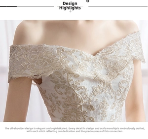 Close-up of exquisite floral lace embroidery and off-shoulder neckline on bridal gown