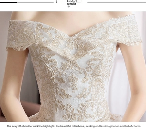 Detailed view of intricate floral champagne lace embroidery on white off-shoulder bridal gown