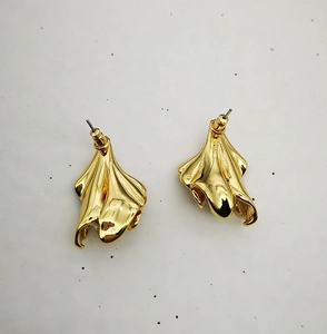 Detail view of 18K gold plated brass petal earrings with textured floral design and pearls