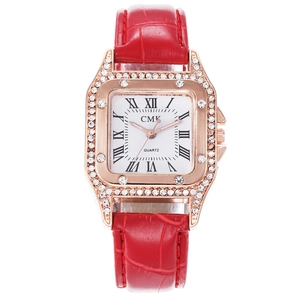 Detail of square rose gold watch case with double row crystals and red leather strap