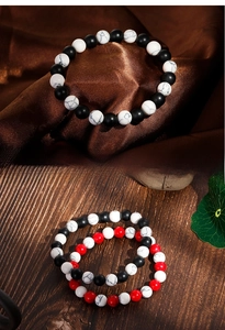 Detail of 8mm matte black agate and white turquoise beaded bracelets for men and women