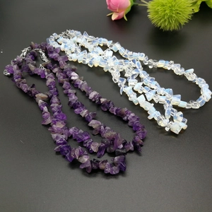 Detail view of irregular amethyst and opal chip bead necklaces with silver lobster clasps