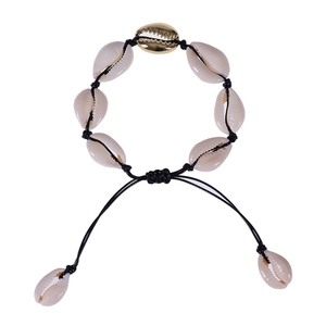 Detail of handmade woven shell bracelet with natural white and gold shell accents