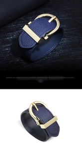 Detail of navy blue faux leather bracelet with polished gold metal buckle clasp