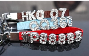 Macro detail of custom 8mm rhinestone letters on colorful lychee pattern leather straps