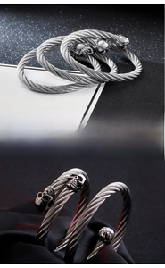 Macro view of woven cable texture and metal skull detailing on a punk steel bangle