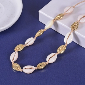 Bohemian gold seashell necklace with natural shells on adjustable woven cord