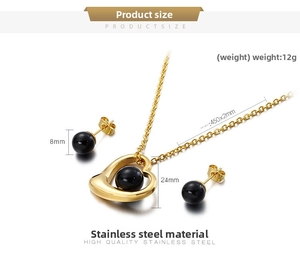 Detailed view of gold stainless steel heart pendant necklace with black bead earrings set