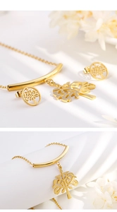 Detailed view of golden Tree of Life necklace and earrings set on white background