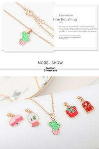 Detailed view of polished enamel cartoon cactus and caravan pendants on gold chain