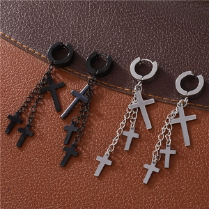 Detail of punk style silver and black stainless steel triple cross tassel drop earrings