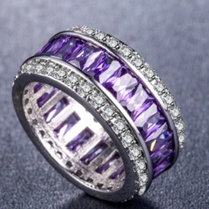 Macro shot of purple rectangle zirconia ring with white side stones in silver band