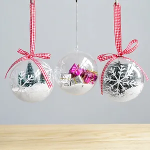 Three transparent Christmas hanging balls with miniature trees and gift box interiors