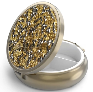 Macro shot of luxury round metal pill box with sparkling rhinestones and inner divider