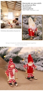 Close-up of handmade Christmas ski dolls with knitted hats and wooden skis for decor