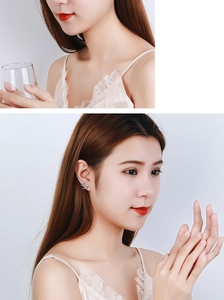Close-up of sparkling heart stud earring in silver finish worn by a female model