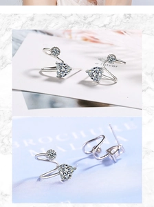 Macro detail of silver heart-shaped earrings with sparkling cubic zirconia crystals