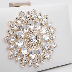 Elegant white evening clutch bag with sparkling crystal flower brooch and gold chain