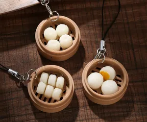 Macro view of realistic ABS dessert steamer keychains on vintage wood background
