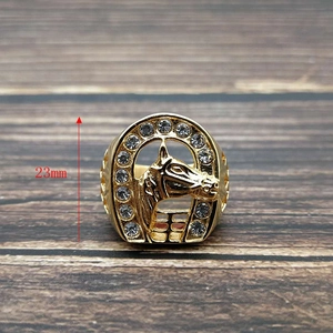Detail of 23mm golden horseshoe ring featuring a carved horse head and inset crystals