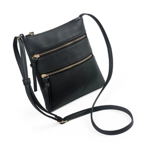 Detailed macro view of high-quality faux leather texture and golden zippers on black bag
