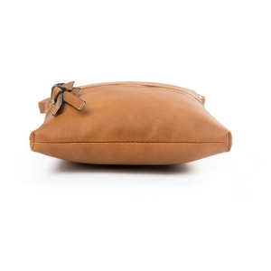 Detail view showing bottom stitching and leather bow of brown vertical crossbody bag