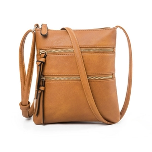 Brown faux leather crossbody bag with multiple zip pockets and gold hardware tassel