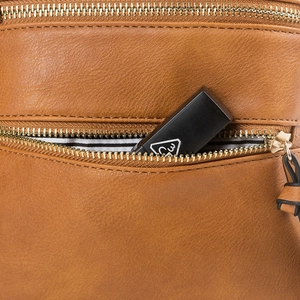 Macro detail of brown leather crossbody bag featuring gold zipper and striped lining