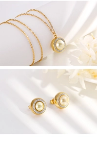 Detailed view of golden pearl and diamond necklace and earring set on white background