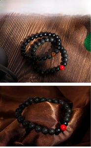 Detail of 8mm matte black beads and lava stone bracelet set with tiger eye accent