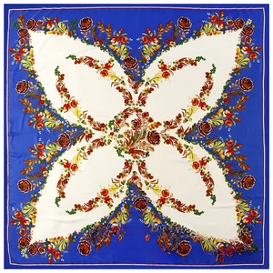 Flat lay detail of silk square scarf featuring vintage floral print and blue border