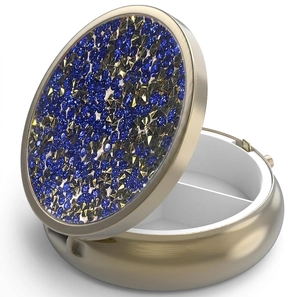 Detail of round metal pill box with blue rhinestone lid and two internal sections