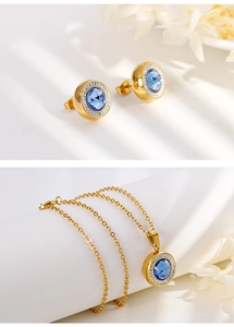Detailed view of golden jewelry set with round blue gemstones and micro-pave crystals